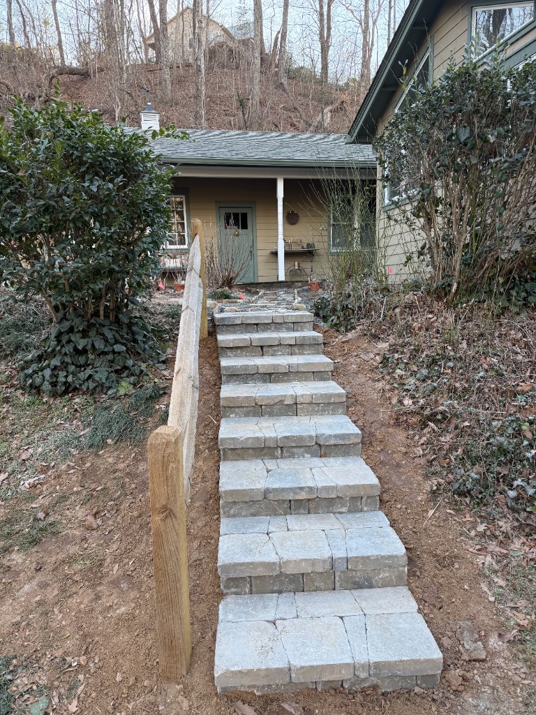 Completed paver staircase leading up a residential slope
